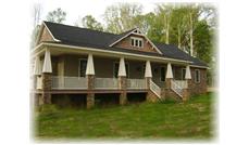 This is a color photo of the front of these craftsman homeplans.
