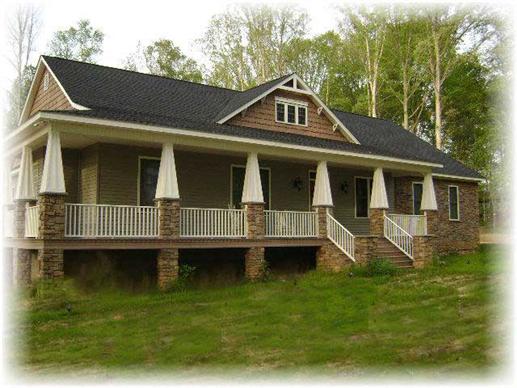 This is a color photo of the front of these craftsman homeplans.