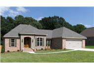 This is a color photo of the front of these Acadian House Plans.
