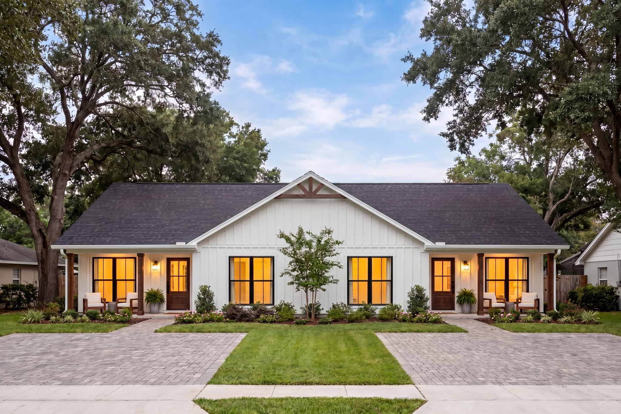 A Modern Farmhouse duplex with board-and-batten siding, steeply pitched gable rooflines, and matching covered front porches anchors this efficient side-by-side plan. 4 beds, 3 baths, 1585 sq ft - Plan #142-1580