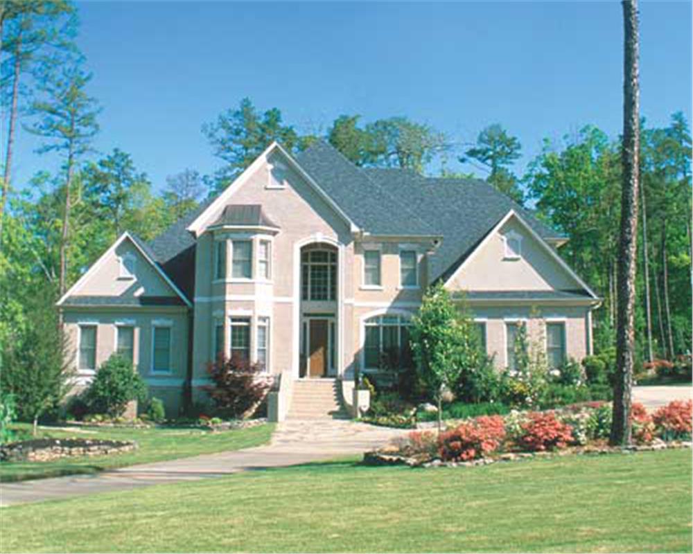Luxurious, traditional home with brick exterior.