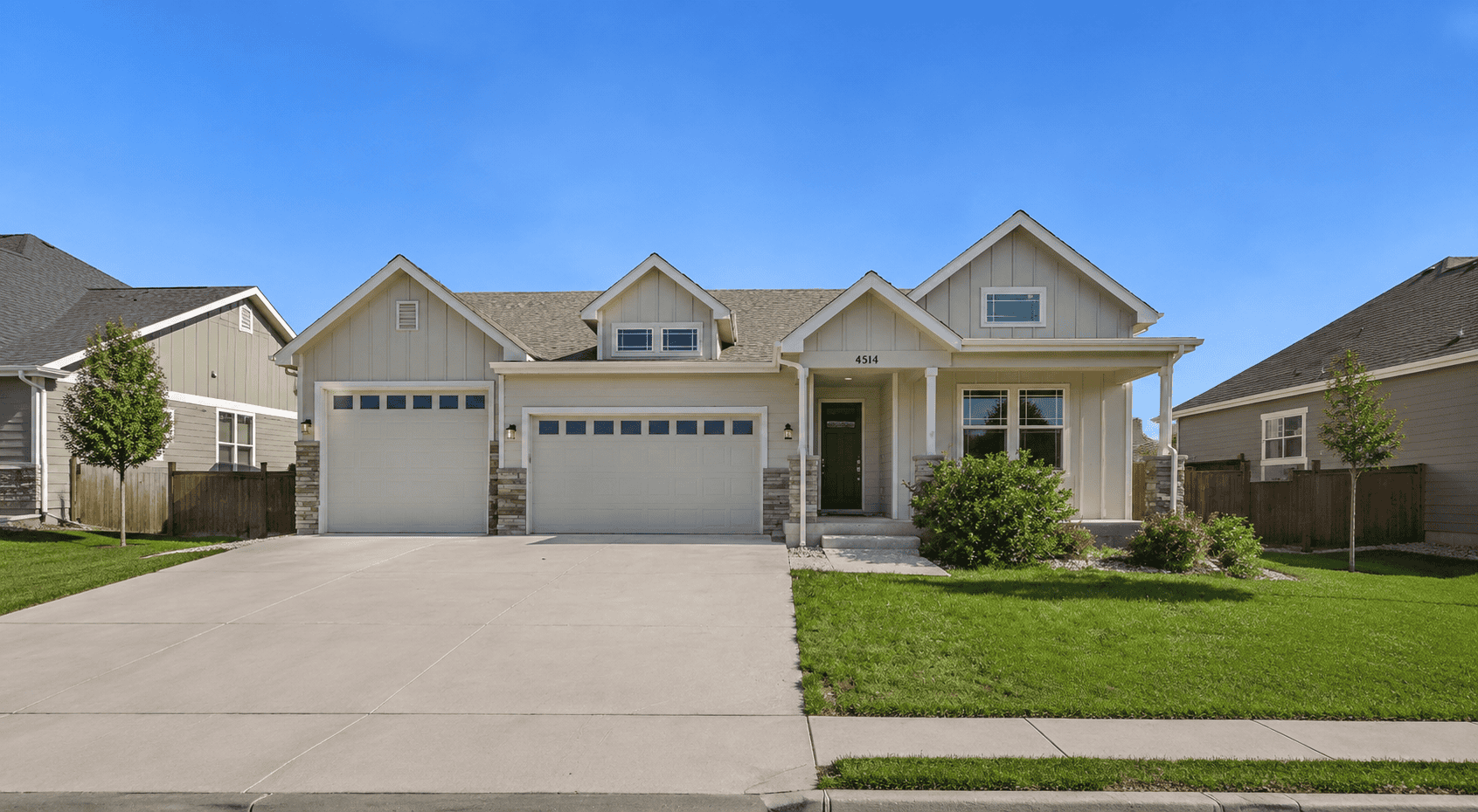 Craftsman Ranch facade with covered front porch, stone accents, and a four-bay garage wing. 3 beds, 1,654 sq ft — Plan #161-1289.