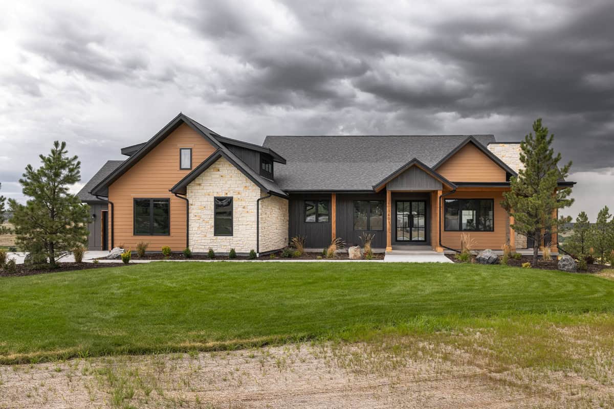 A Craftsman Ranch home with stone-accented entry gable, mixed siding, and a side-entry 3-car garage. 2 beds, 2,468 sq ft — Plan #161-1293.