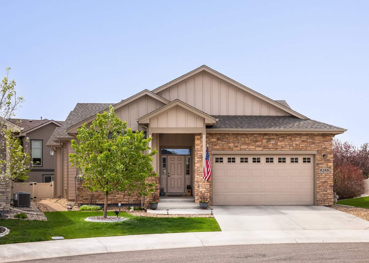 A Ranch home with covered front porch, mixed stone and board-and-batten wall materials, and a combined gable and hip roof. 3 beds, 1,904 sq ft - Plan #161-1317.