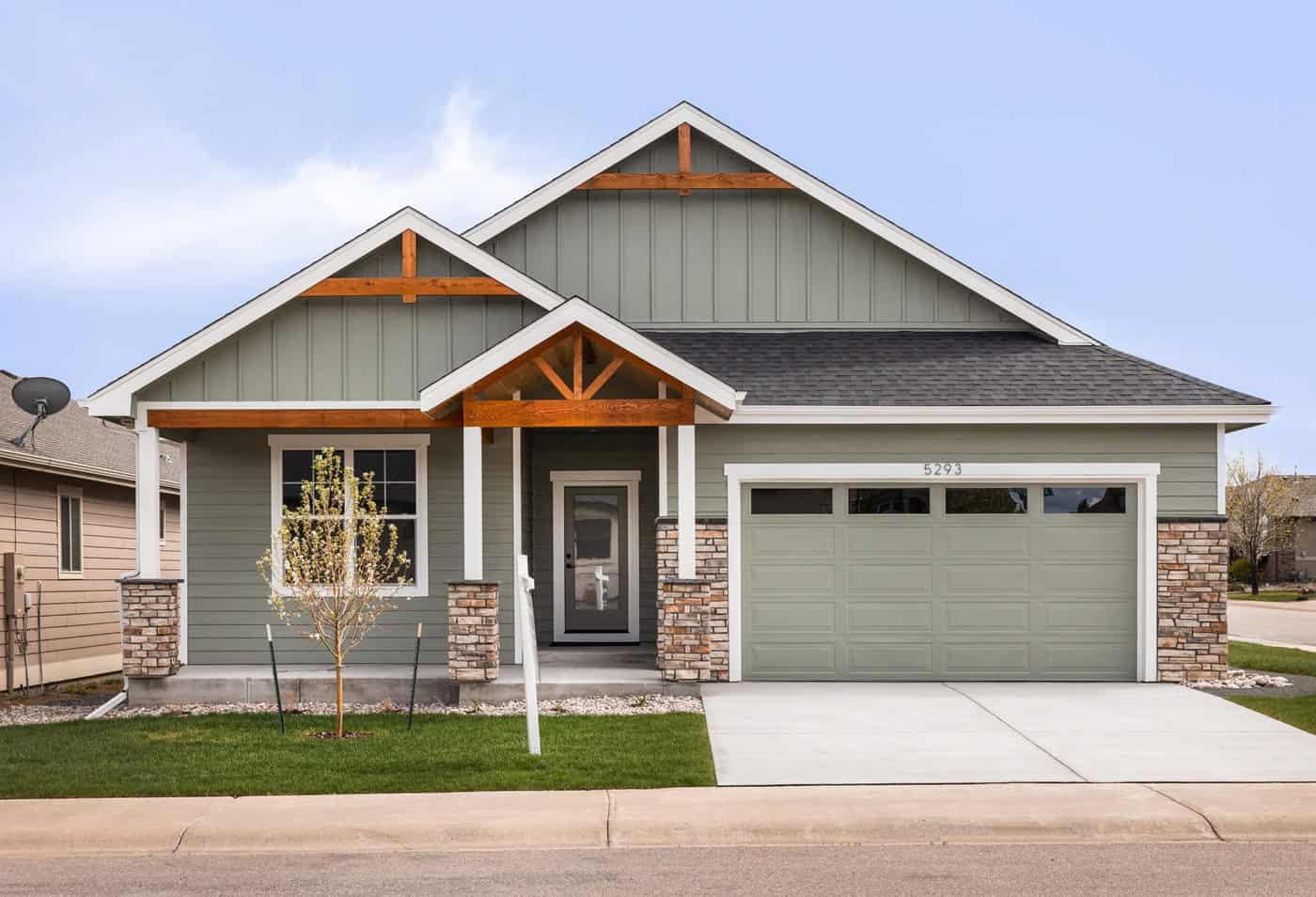 A Ranch home with mixed stone and board-and-batten siding, gable roof, and covered front porch entry. 2 beds, 1,787 sq ft - Plan #161-1334