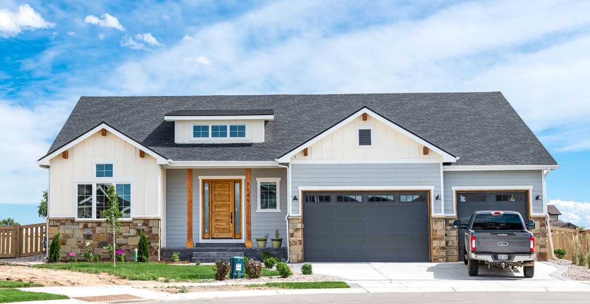 A Modern Farmhouse home with stone and shiplap siding, board-and-batten accents, and a covered front porch. 3 beds, 2.5 baths, 2,228 sq ft - Plan #161-1338