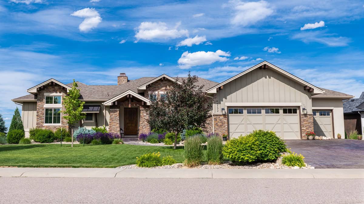 Craftsman home elevation with stone and board-and-batten siding, covered front porch, and gable roofline. 1 bed, 2,240 sq ft - Plan #161-1339