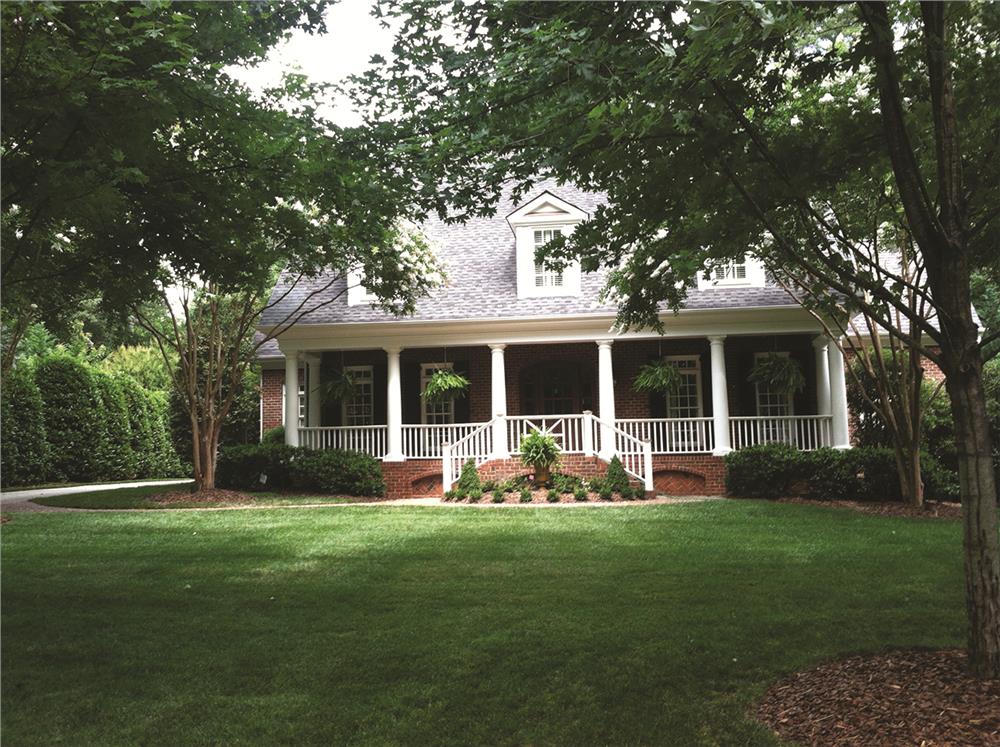 Photo of this Southern country home with wide porch. (ThePlanCollection: House Plan #180-1024)