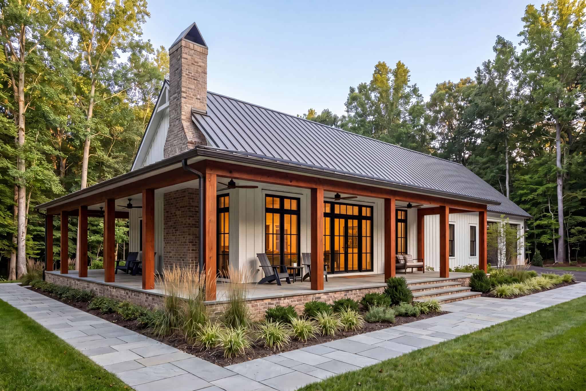 Single-story Barndominium exterior with wraparound porch, board-and-batten siding, and 3-car side-entry garage — Plan #142-1573