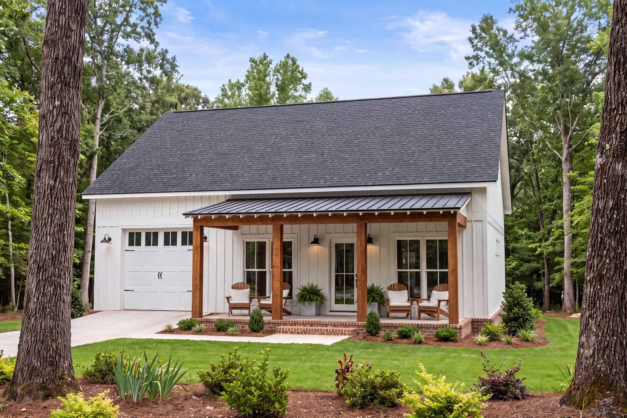 Board and batten barndominium with covered front porch, gable roof, and multi-pane windows. 2 beds, 1,200 sq ft - Plan #142-1582.
