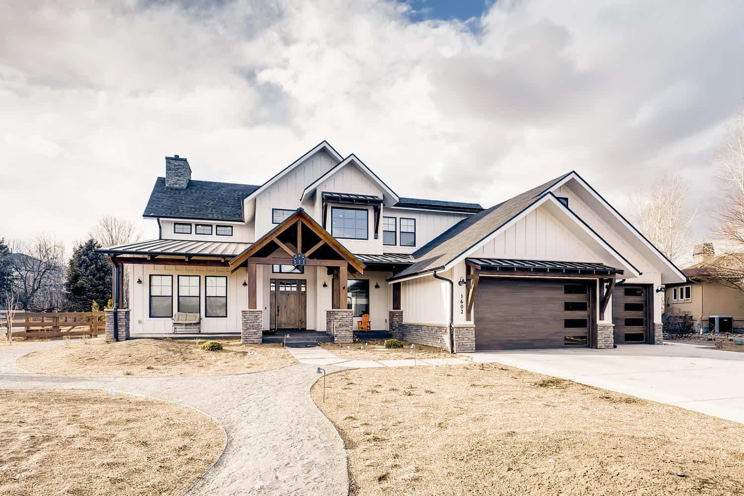 Two-story Modern Farmhouse with board-and-batten siding, stone accents, covered front porch, and gable metal roof, Plan 161-1283