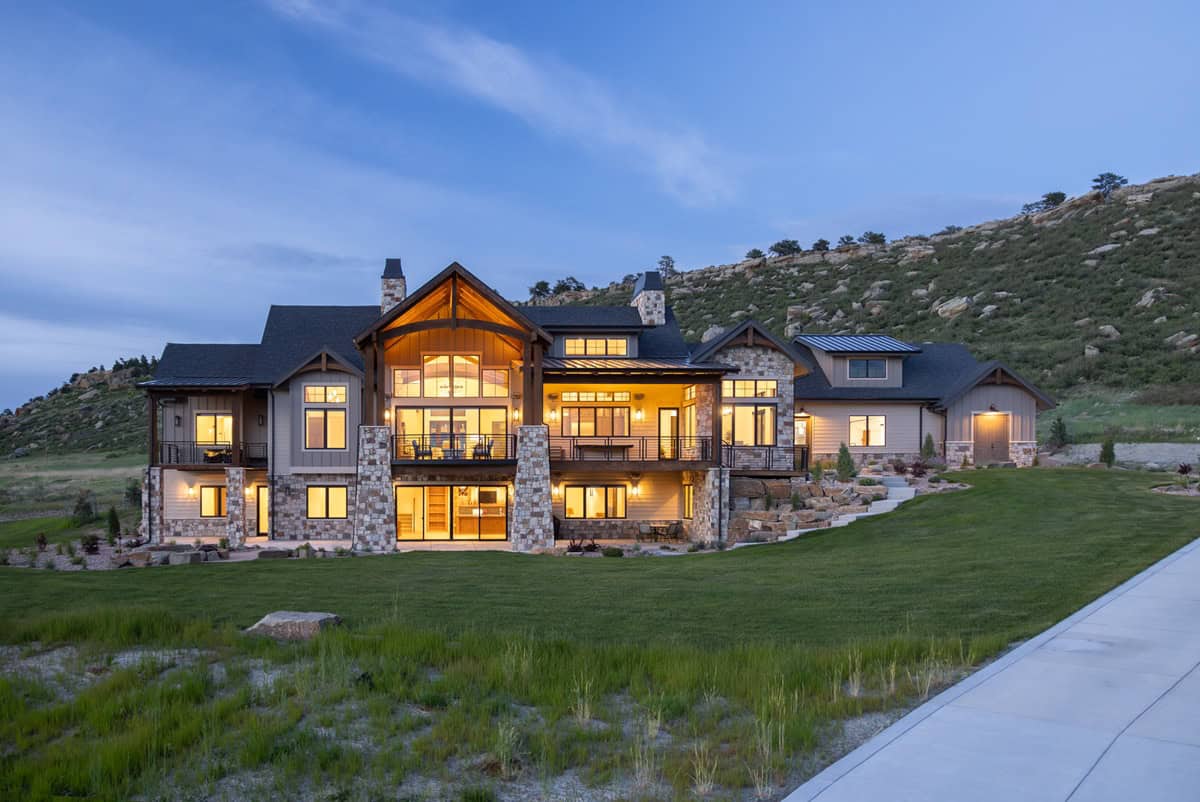 Rustic house plan 161-1290 exterior with stone entry piers, board-and-batten gables, and side-entry 5-car garage