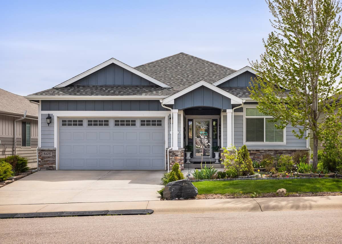 Front elevation of Craftsman Ranch home with stone accents, covered front porch, and gable-hip roofline, Plan 161-1294