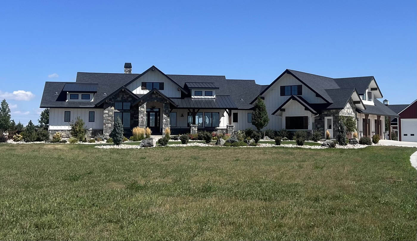 Modern Farmhouse home with board-and-batten siding, stone accents, gabled metal roof, and courtyard-entry garage, Plan 161-1299