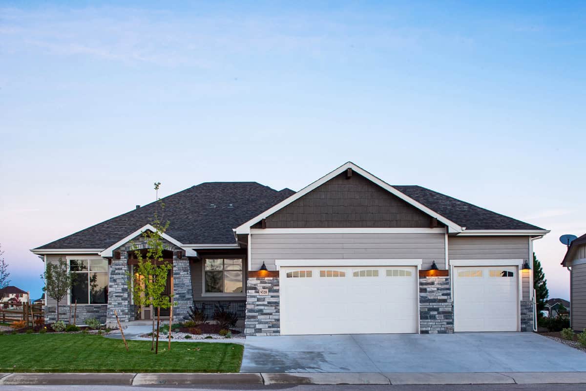 Craftsman Ranch home with stone accents, lap-siding exterior, gable roofline, covered porch, and front-entry garage — Plan #161-1337