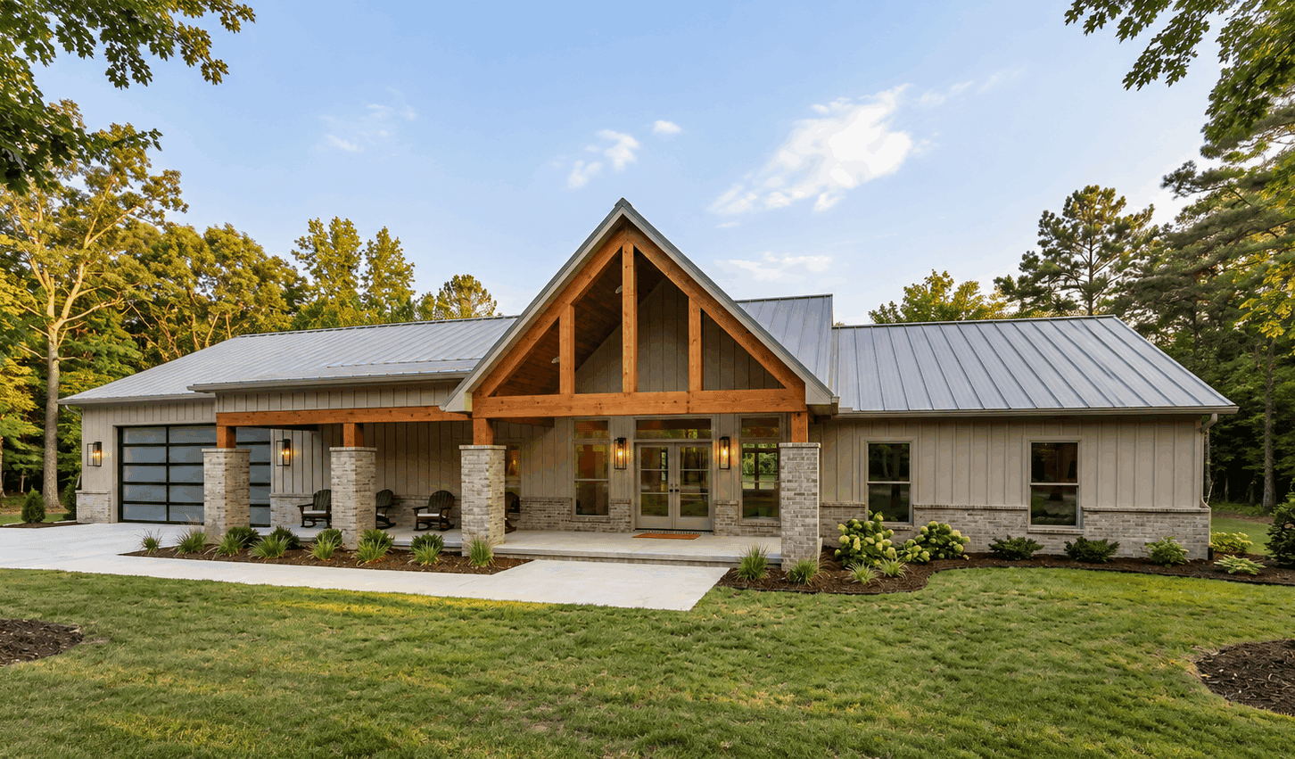 Modern Farmhouse facade with covered front porch, metal gable roof, and stone accents. Five-bedroom, 2,516 sq ft single-story plan #221-1016.