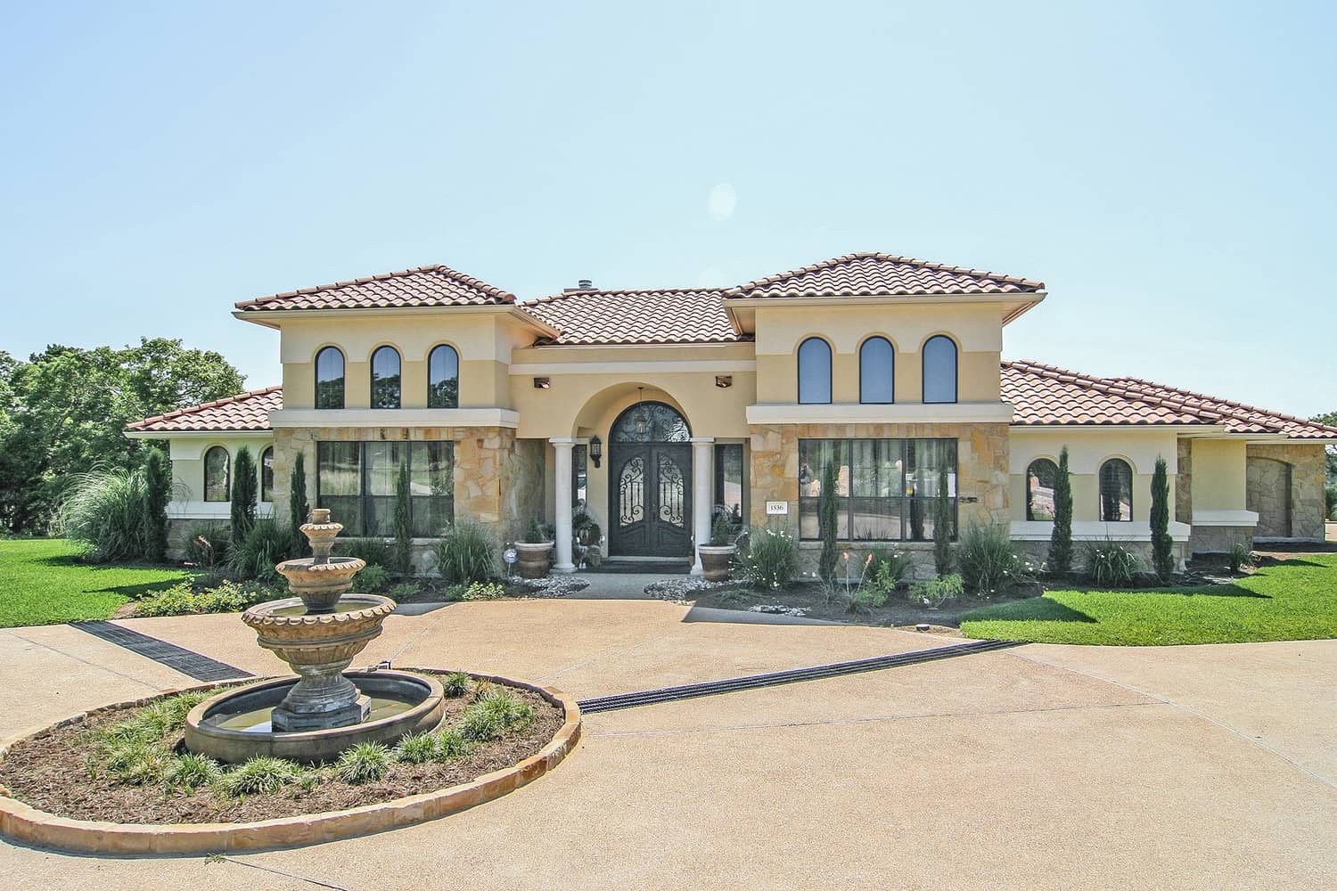 Front elevation of Texas Style home (ThePlanCollection: House Plan #136-1031)