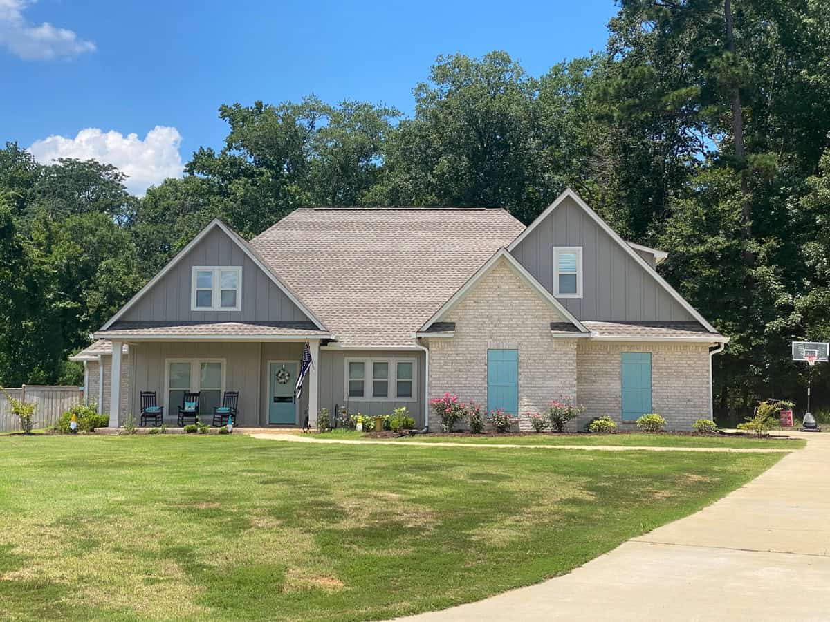 A Traditional home with three front-facing gables, a brick entry bay, and a covered front porch with square posts. 3 beds, 2,330 sq ft - Plan #140-1145.
