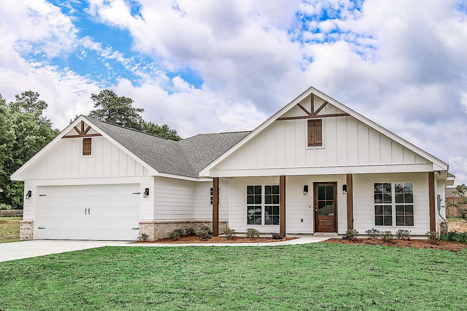 This image showcases a charming Ranch-style home with a covered front porch, forward-facing gables, and natural wood timber trim, embodying a welcoming country aesthetic. Plan #142-1271.