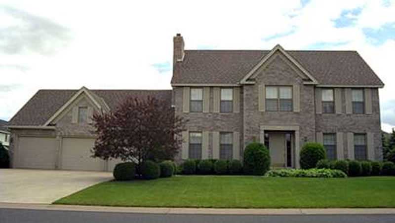 Front view of Colonial home (ThePlanCollection: House Plan #146-2876)