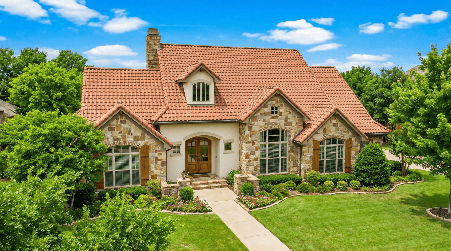 Front elevation of Tuscan home (ThePlanCollection: House Plan #153-1153)