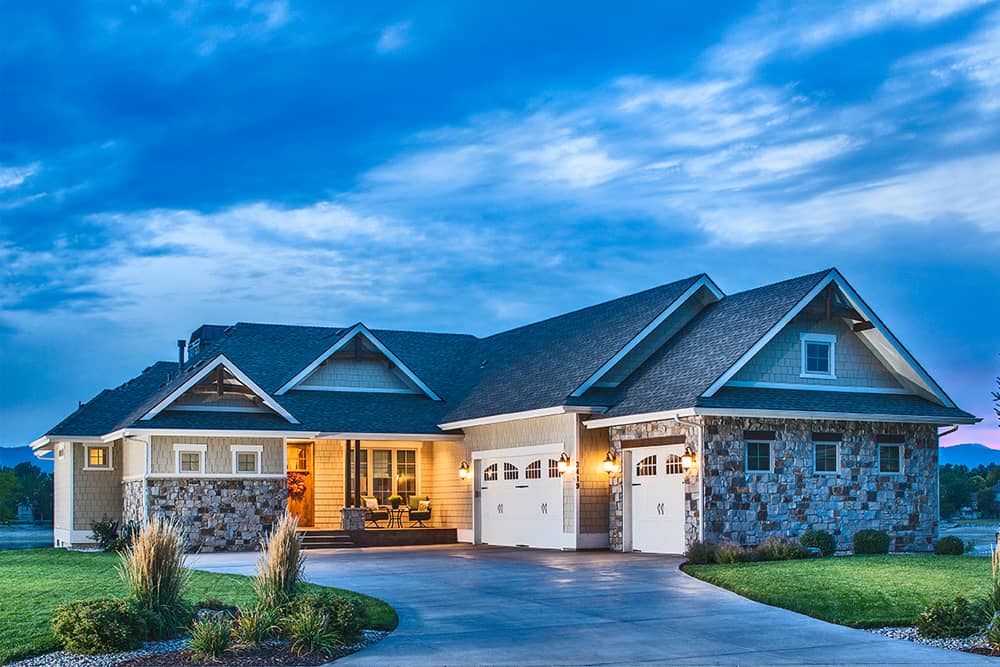 Color photograph of Craftsman home at dusk (ThePlanCollection: House Plan #161-1081)