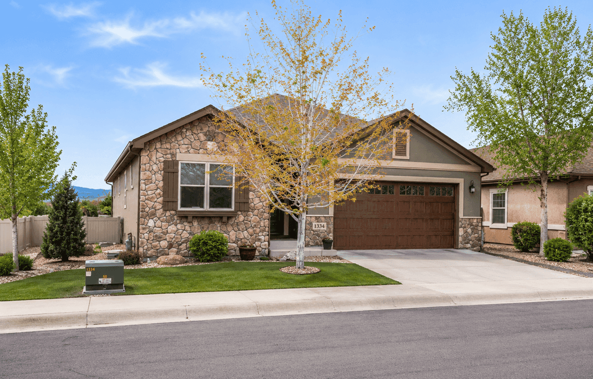 A Southwest home with smooth stucco walls, stone accents, and a covered front porch. 2 beds, 1,655 sq ft — Plan #161-1296.