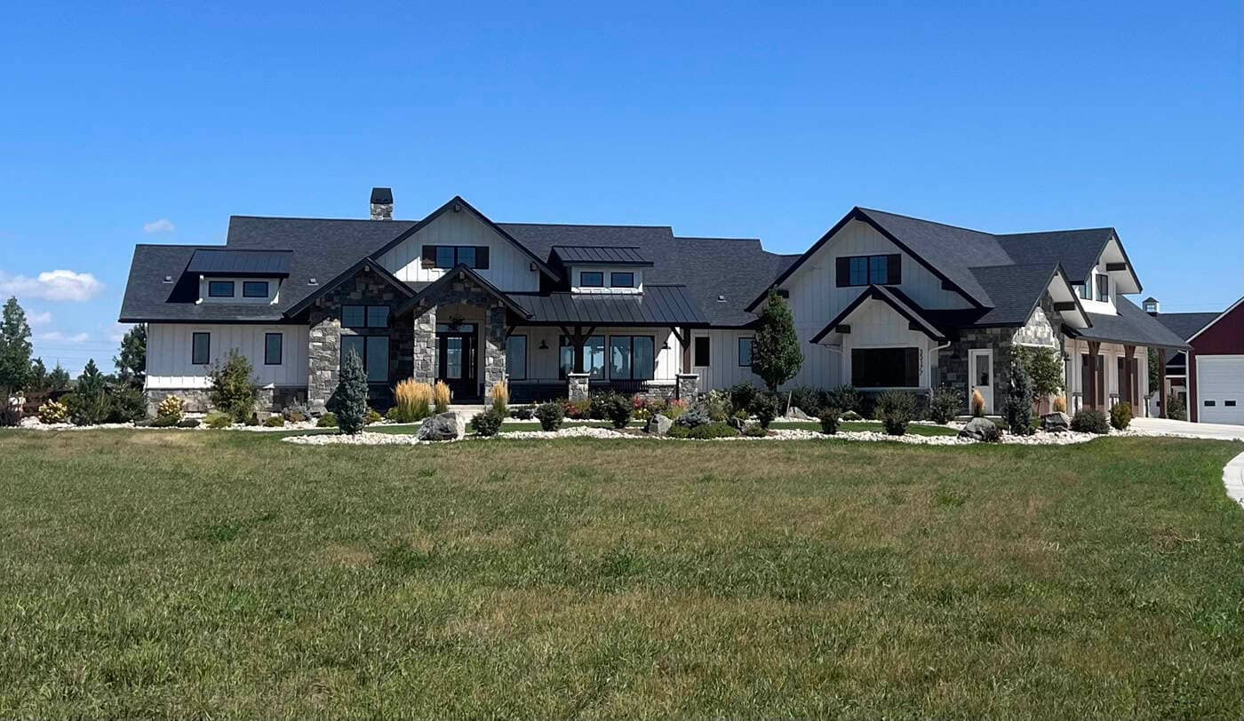 A Modern Farmhouse design with board-and-batten siding, stone accents, and a courtyard-entry garage. 2 beds, 2,729 sq ft — Plan #161-1299.