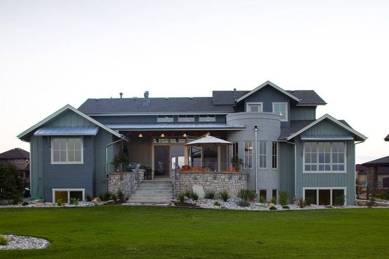 A Craftsman home with stone accents, board-and-batten gables, and a covered front porch. 4 beds, 3,959 sq ft — Plan #161-1309.