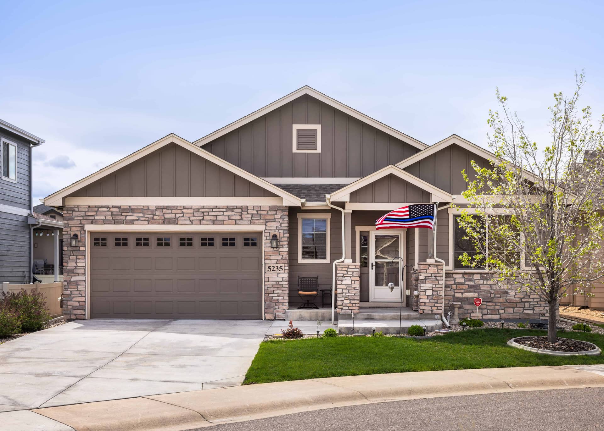 Craftsman facade with covered front porch, stone accents, and board and batten siding. 3 beds, 1,794 sq ft - Plan #161-1313.