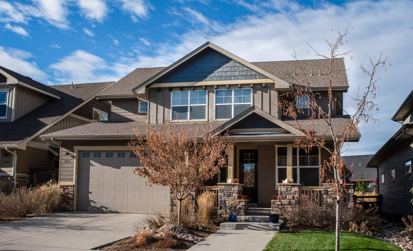 Craftsman facade with covered front porch, stone accents, and gable-front entry. 4 beds, 2,105 sq ft - Plan #161-1331