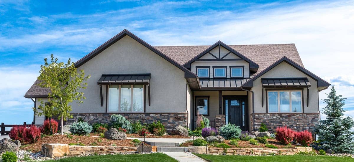 Modern farmhouse ranch elevation with covered front porch, board-and-batten siding, and gable roofline. Open floor plan with split bedroom layout, 3-car front-entry garage, and covered outdoor living spaces. 2 beds, 2.5 baths, 2,531 sq ft - Plan #161-1335
