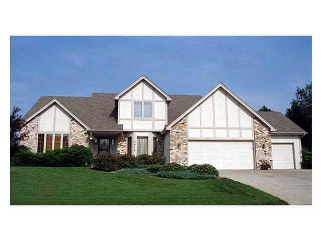 This colored photo shows the front elevation of these Tudor Houseplans.