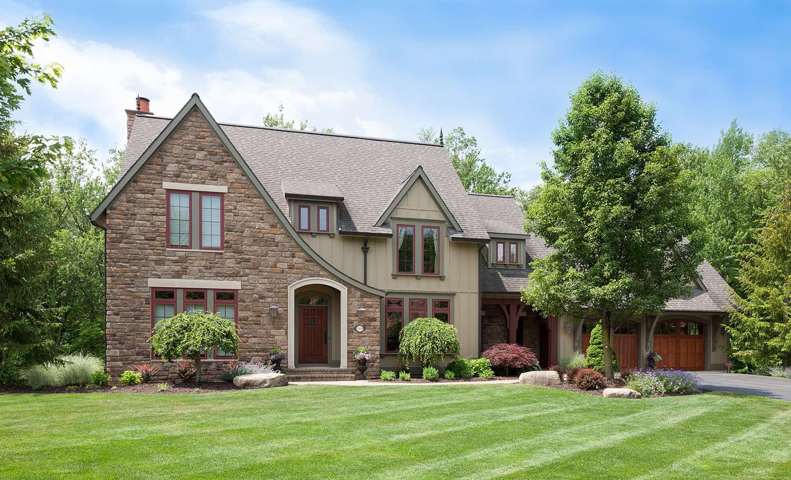 Front elevation of Tudor home (ThePlanCollection: House Plan #168-1147)