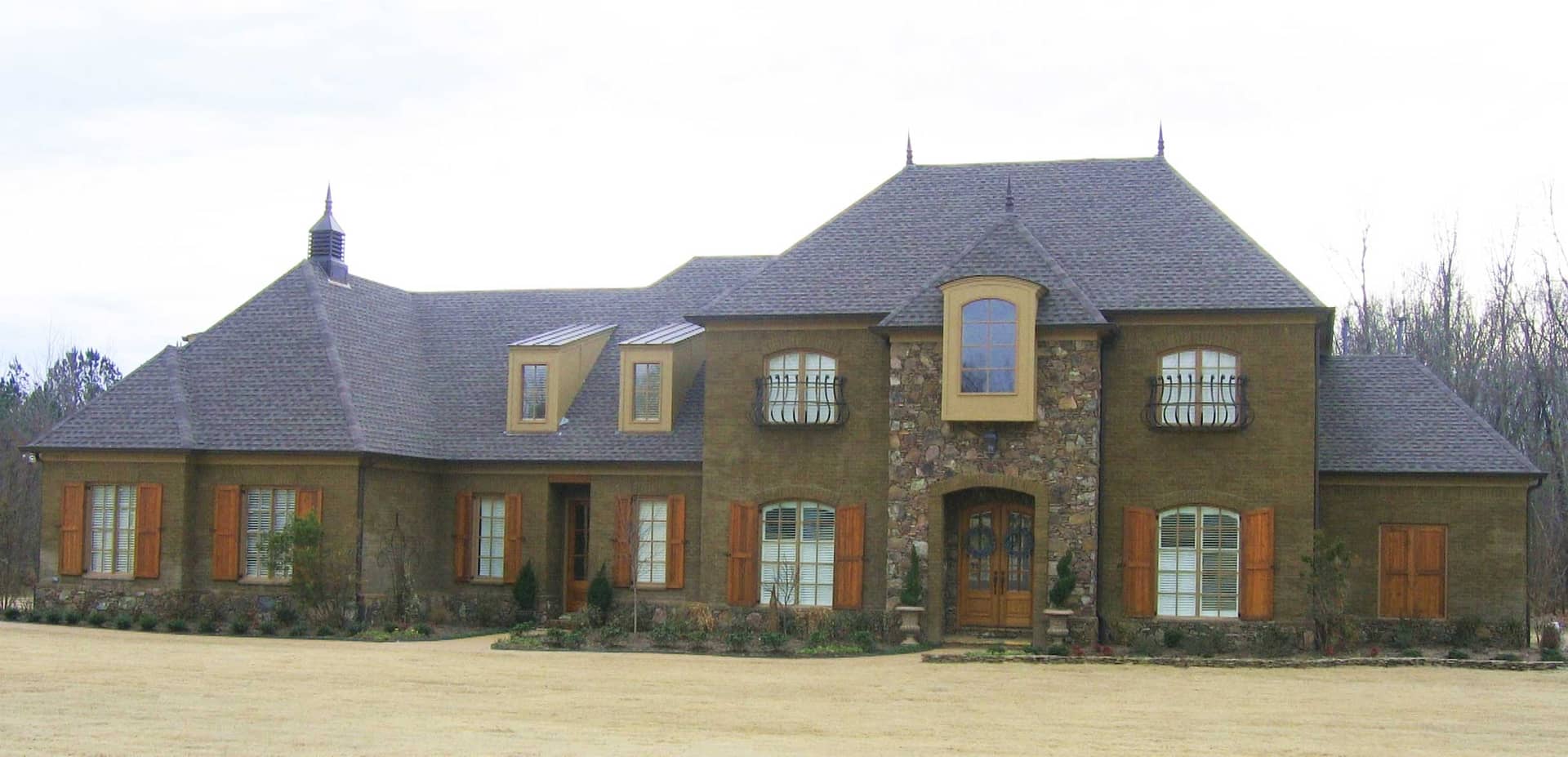 Front view of French home (ThePlanCollection: House Plan #170-1507)