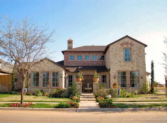 Front elevation of Tuscan home (ThePlanCollection: House Plan #195-1135)