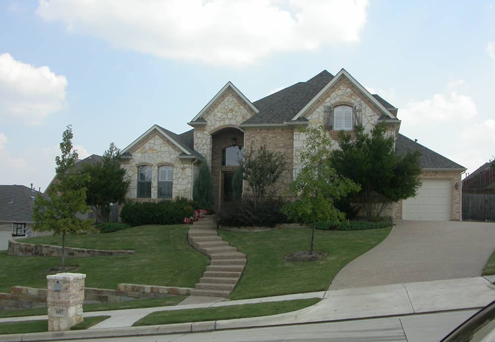 Front elevation of Tudor home (ThePlanCollection: House Plan #195-1146)