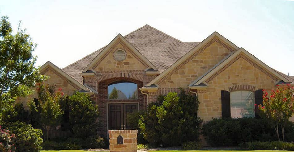 Front elevation of Tudor home (ThePlanCollection: House Plan #195-1147)