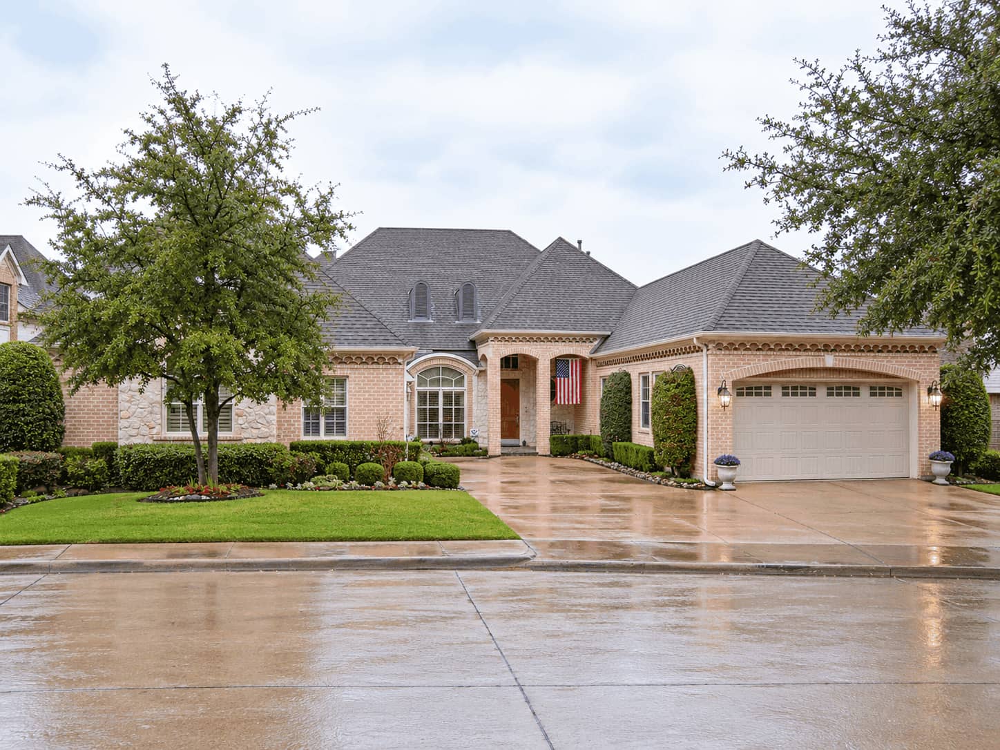 European brick exterior with an arched entry porch, matching arched window, and steep hip roofs. 3 beds, 3,189 sq ft - Plan #195-1373
