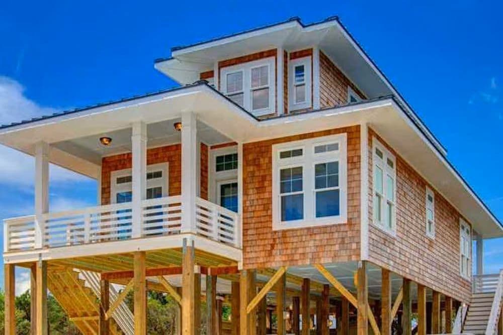 A coastal home elevated on a system of foundation piers.