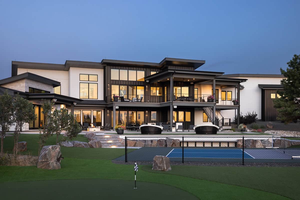 A Modern home with stepped flat rooflines, stone-clad entry, and side-entry six-car garage. 2 beds, 3,553 sq ft - Plan #161-1285.
