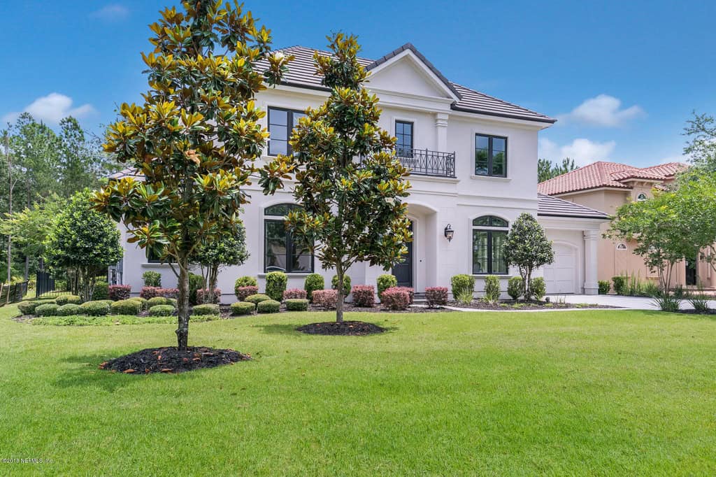 A two-story Florida Style home with stucco exterior, tile roof, and columned portico entry. 4 beds, 3,228 sq ft — Plan #161-1300.