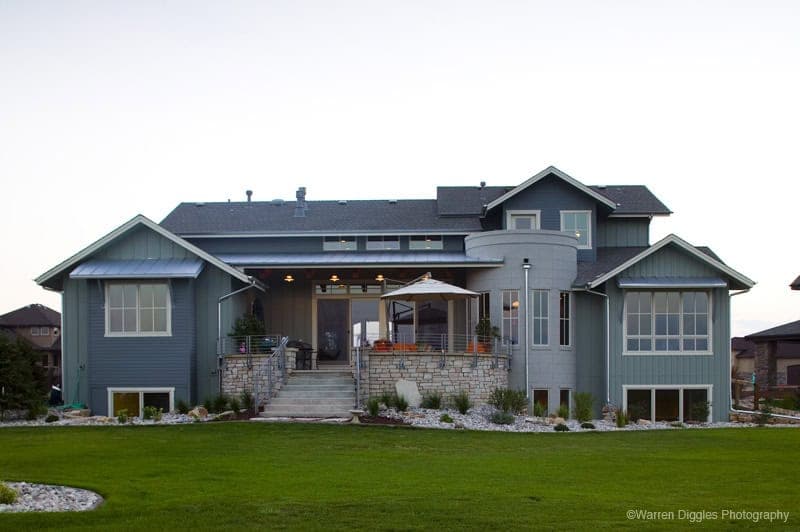 A Craftsman home with stone accents, board-and-batten gables, and a covered front porch. 4 beds, 3,959 sq ft — Plan #161-1309.