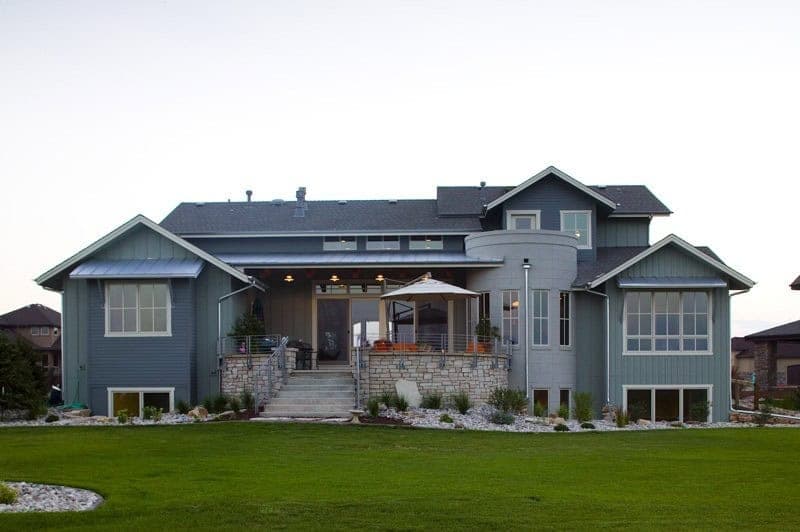 A Craftsman home with stone accents, board-and-batten gables, and a covered front porch. 4 beds, 3,959 sq ft — Plan #161-1309.