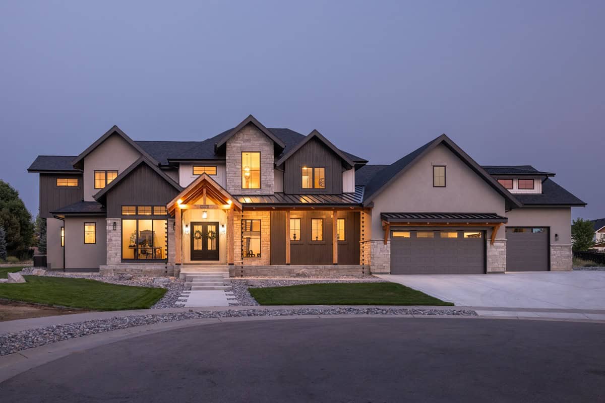 A 2-story Modern Farmhouse features board-and-batten siding, a covered front porch, and a 6-car garage structure. 4 beds, 4,052 sq ft - Plan #161-1341