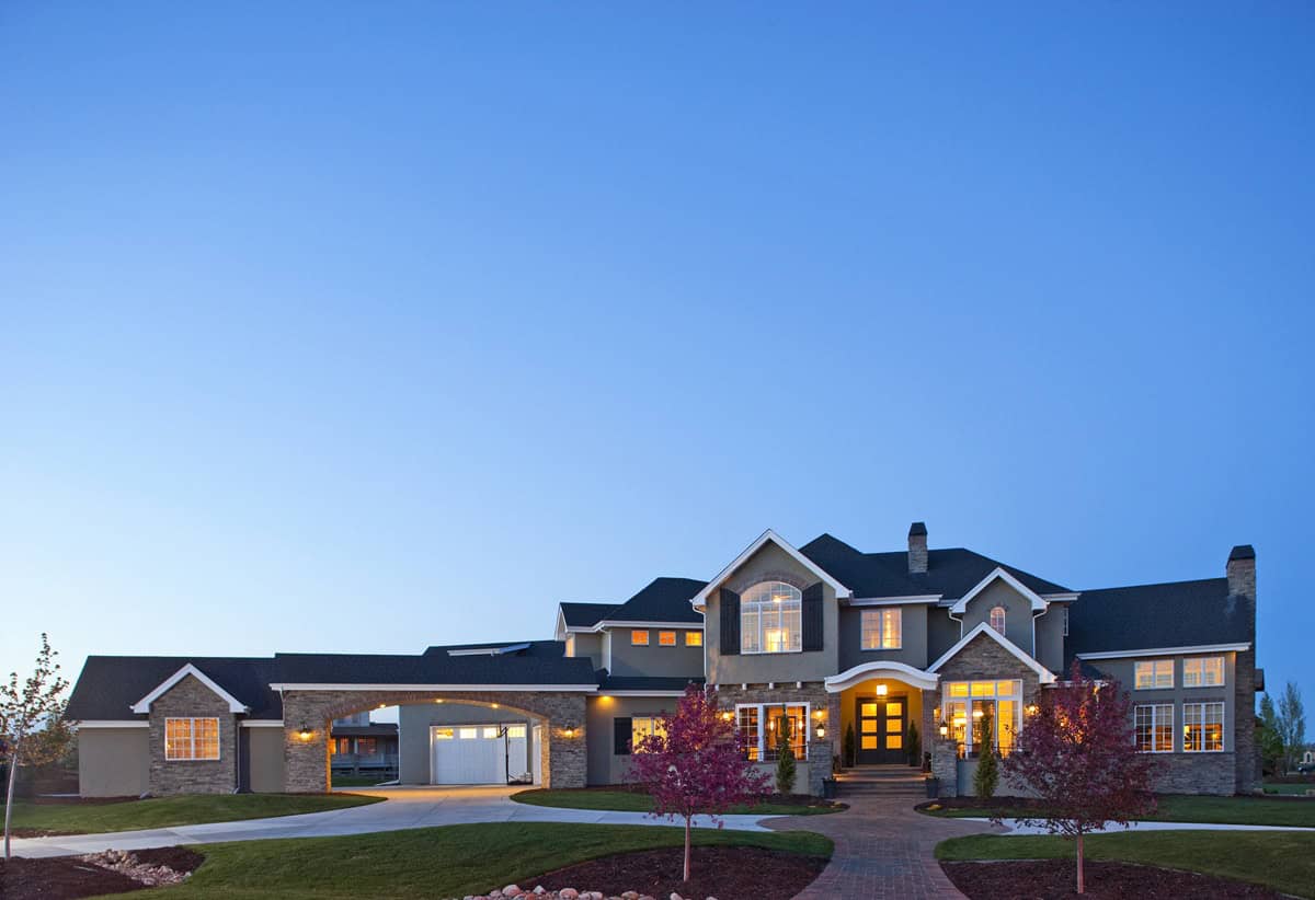 European luxury facade with stucco and stone detailing, courtyard entry, and gabled roofline composition. 3 beds, 4,608 sq ft - Plan #161-1342