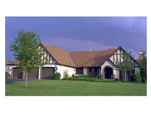 This is a photo of the front elevation of these Tudor Houseplans (CLS-3202).