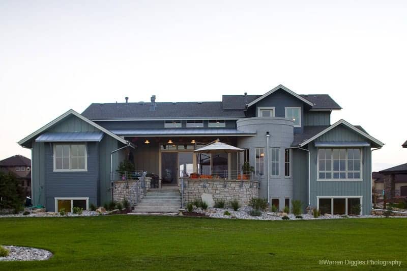 A Craftsman home with stone accents, board-and-batten gables, and a covered front porch. 4 beds, 3,959 sq ft — Plan #161-1309.