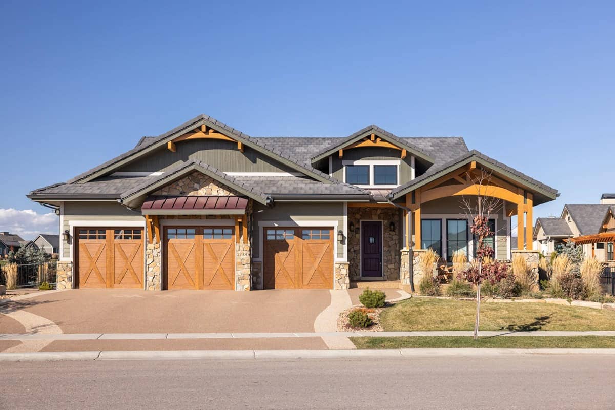 A rustic Craftsman design with stone accents, board-and-batten gables, and metal roof details. 3 beds, 2,395 sq ft - Plan #161-1314.