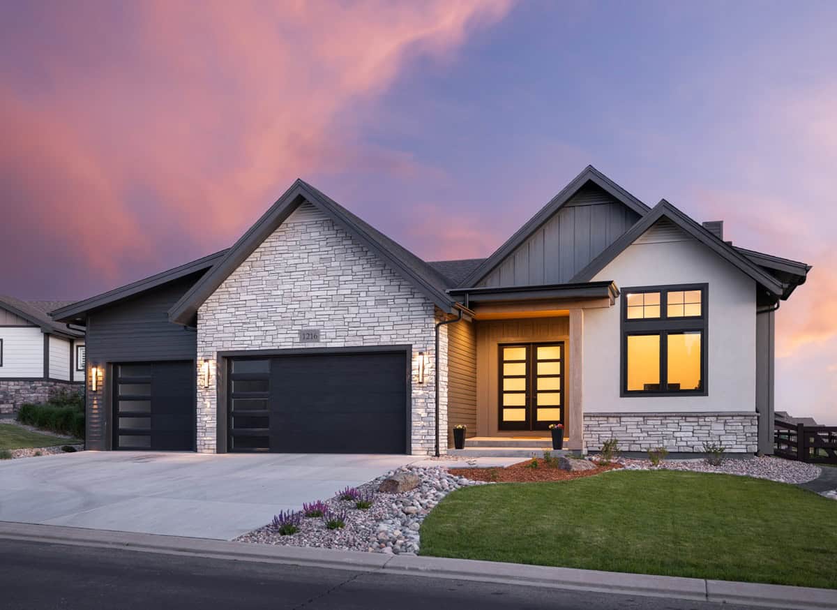 Modern Farmhouse elevation with board-and-batten siding, stone accents, gable roofline, and covered front porch. 2 beds, 2,163 sq ft - Plan #161-1321